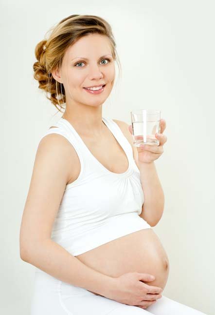 pregnant woman with a glass of water