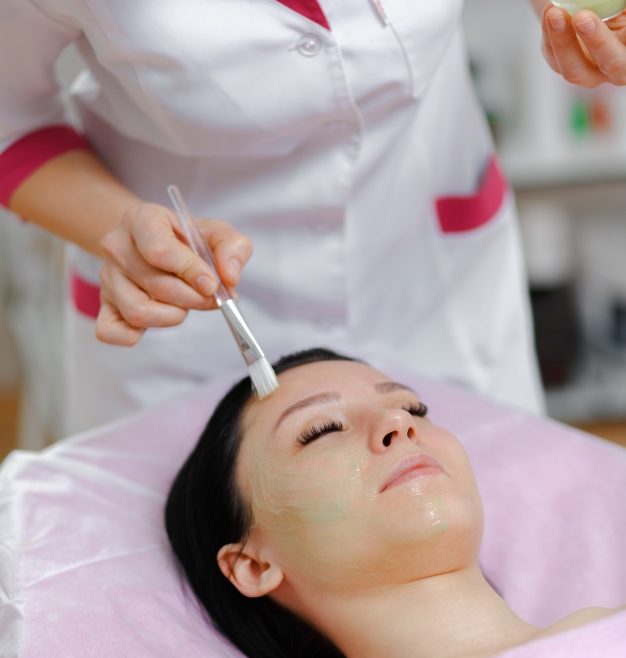 professional woman applying green cream with a brush 1208 313